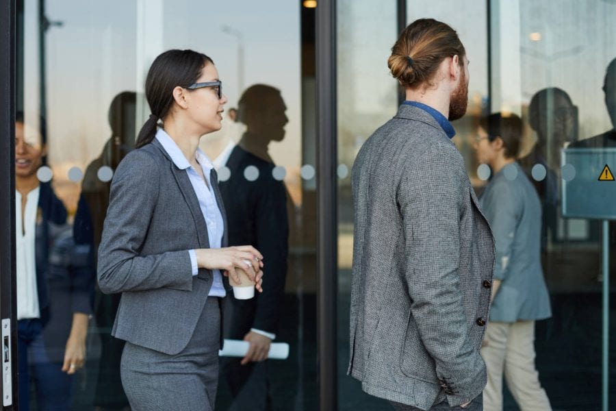 Customers coming and going through a revolving door