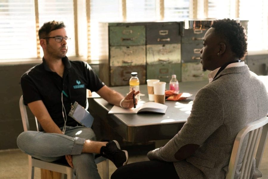 Business representative speaks with client at table