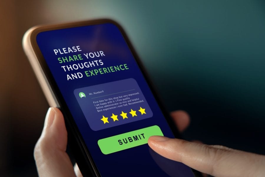 Mobile phone screen with customer feedback window open and five-star review