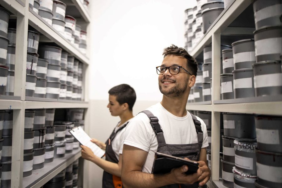 Business owners organising inventory shelves