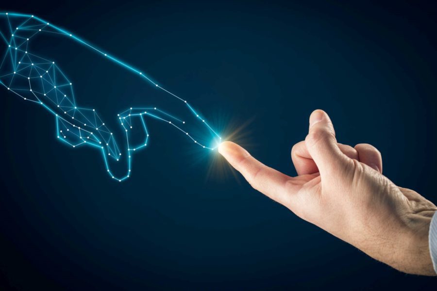 Human hand touching AI hand