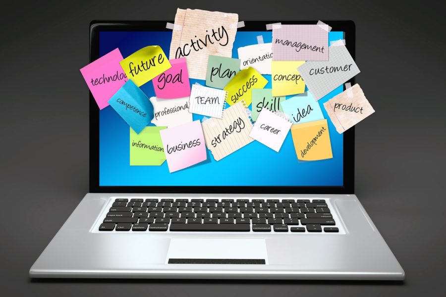 Bulletin board of ideas on stickies posted on a laptop for a new business start-up