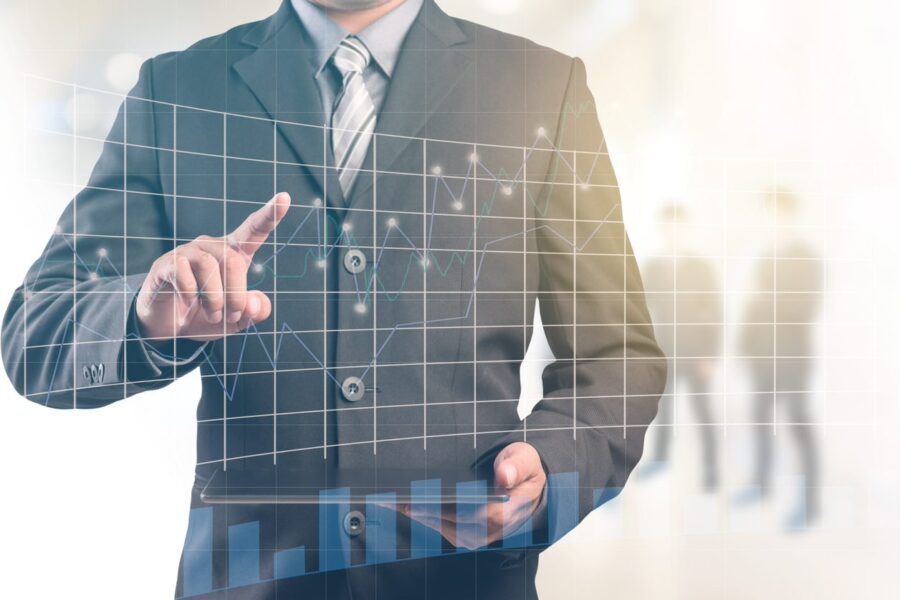 Businessman working with a digital tablet with graph in the foreground.
