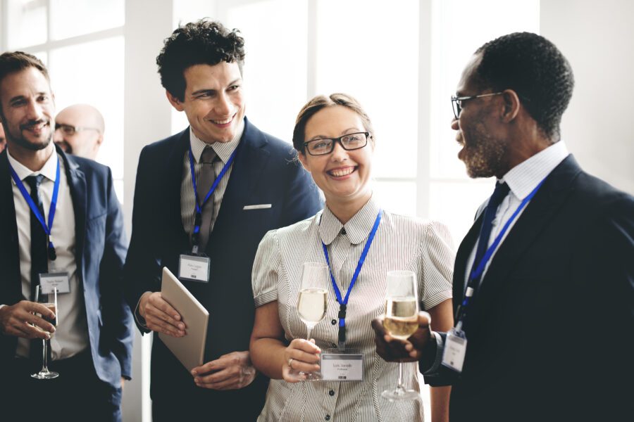 Group of businesspeople smiling and talking with each other