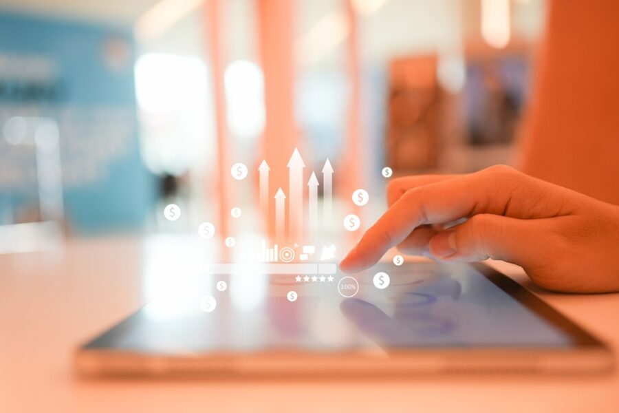 A close-up of a hand touching a screen on a digital tablet to use marketing tools for an online b2b business.