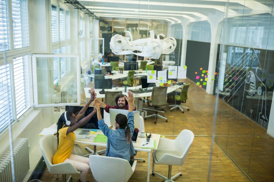 Group of employees giving high five to each other