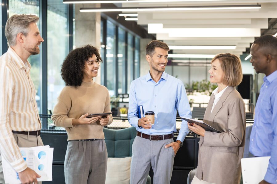 Group of happy, progressive businesspeople, working together in a creative office.